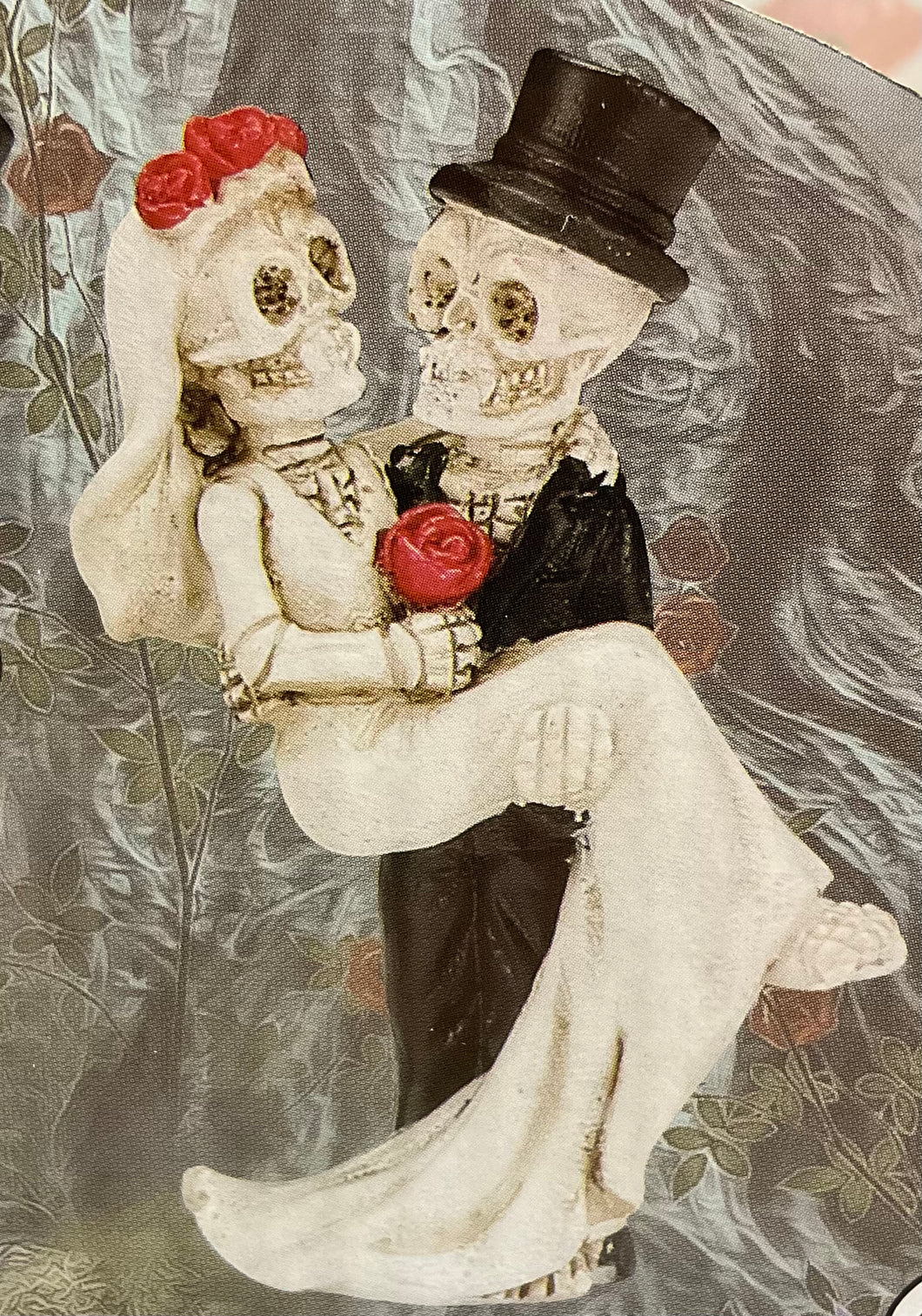 Skeleton groom holding bride figurine